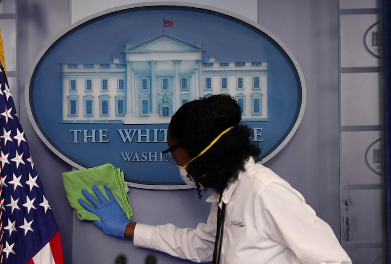 Workers clean the area around the podium before the daily coronavirus outbreak task force briefing at the White House, Washington, US. Reuters