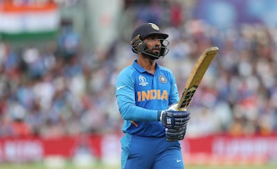 India's Dinesh Karthik leaves the field after being dismissed by New Zealand's Matt Henry during the Cricket World Cup semi-final match between India and New Zealand at Old Trafford in Manchester, England, Wednesday, July 10, 2019. (AP Photo/Aijaz Rahi)