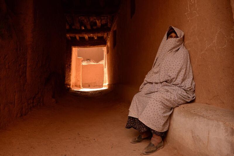 A veiled woman sits in the old part of the central eastern Moroccan city of Tinghir. Faded Senna / AFP 
