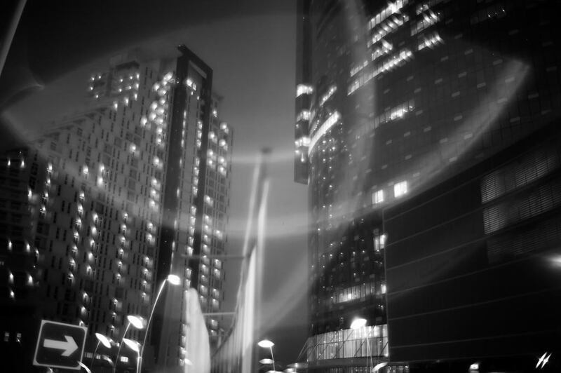 Lights from towers of Reem Island illuminate a construction site below. Brian Kerrigan / The National