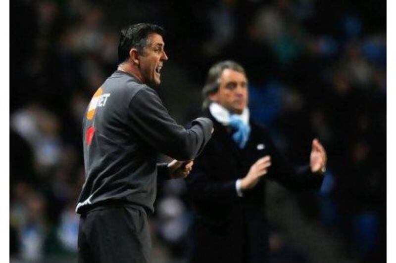 Owen Coyle, the Bolton manager, hopes to get the better of Roberto Mancini today. 

Laurence Griffiths / Getty Images