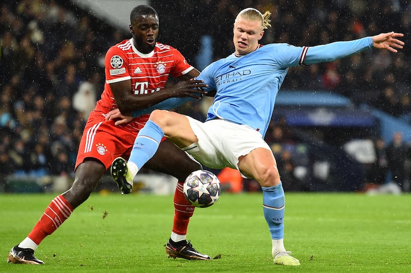 Erling Haaland of Manchester City in action against Dayot Upamecano of Bayern. EPA 