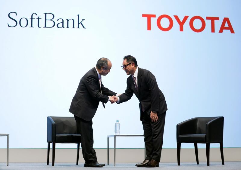 epa07068214 SoftBank Corp. Chief Executive Officer Masayoshi Son (L) and Toyota Motor Corp President Akio Toyoda (R) shake hands during a joint announcement of their new venture to develop mobility services in Tokyo, Japan, 04 October 2018. SoftBank Corp. and Toyota Motor Corp. announced on 04 October 2018 that they will make a joint venture company MONET Technologies Corporation to develop mobility services.  EPA/KIMIMASA MAYAMA