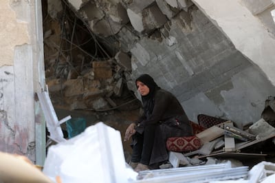 A Palestinian woman sits amid the rubble of a building in the Jabalia refugee camp in northern Gaza. AFP