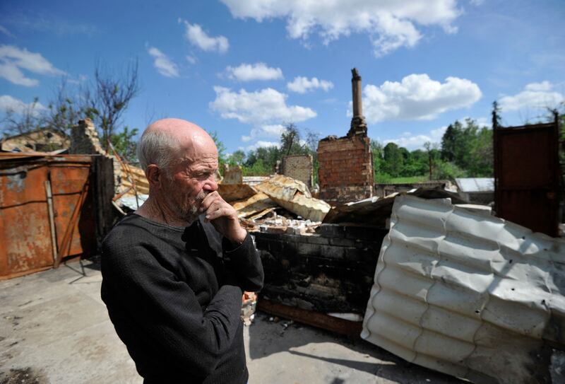 A man reacts at the site where his house once stood in Motyzhyn village in the Kyiv region. AFP