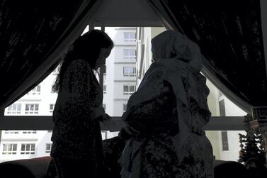 Azliya, (right), with one of her teenage daughters SS at her home in Dubai, is hoping to finally legalise her status in the UAE. Pawan Singh / The National