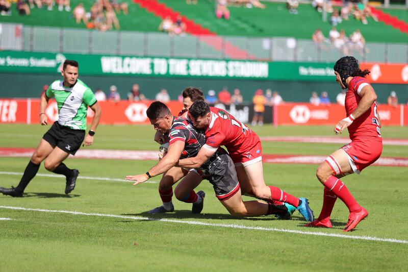 Dubai Exiles' Justin Walsh scores.