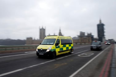 LONDON, ENGLAND - DECEMBER 28: An ambulance crosses Westminster Bridge on December 28, 2020 in London, United Kingdom. Patient demand for the London Ambulance Service is "now arguably greater" than during the first wave, according to an internal message recently sent to LAS staff. The UK is experiencing a surge in COVID-19 cases amid reports of a new variant of the virus that may be faster spreading. (Photo by Hollie Adams/Getty Images)