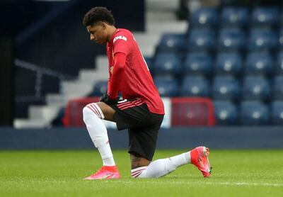 Soccer Football - Premier League - West Bromwich Albion v Manchester United - The Hawthorns, West Bromwich, Britain - February 14, 2021 Manchester United's Marcus Rashford kneels in support of the Black Lives Matter campaign before the match Pool via REUTERS/Nick Potts EDITORIAL USE ONLY. No use with unauthorized audio, video, data, fixture lists, club/league logos or 'live' services. Online in-match use limited to 75 images, no video emulation. No use in betting, games or single club /league/player publications.  Please contact your account representative for further details.