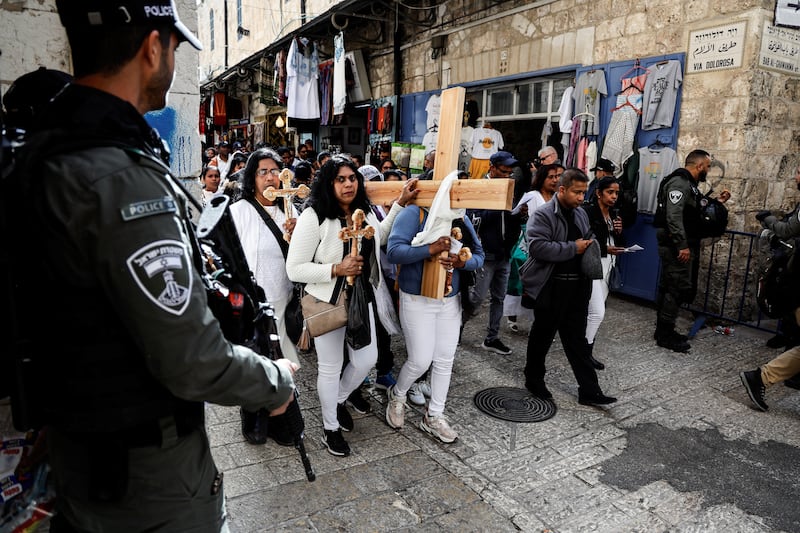 Worshippers carry a cross as they take part in the Good Friday procession in Jerusalem's Old City. Reuters