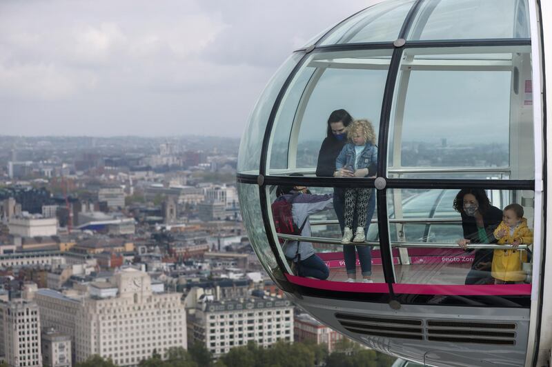 Passengers ride in a capsule of the London Eye as the attraction reopened on the day England implemented the third step of its road map out of lockdown. Reuters