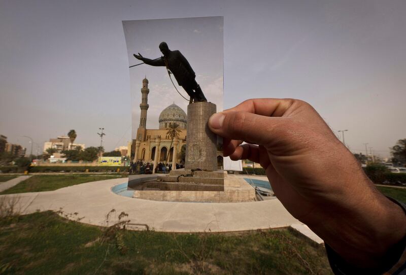 This Wednesday, March 13, 2013 photo shows a general view of Firdous Square at the site of an Associated Press photograph taken by Jerome Delay as the statue of Saddam Hussein is pulled down by U.S. forces and Iraqis on April 9, 2003. Ten years ago on live television, U.S. Marines memorably hauled down a Soviet-style statue of Saddam, symbolically ending his rule. Today, that pedestal in central Baghdad stands empty. Bent iron beams sprout from the top, and posters of anti-American Shiite cleric Muqtada al-Sadr in military fatigues are pasted on the sides.(AP Photo/Maya Alleruzzo) *** Local Caption ***  Mideast Iraq On This Site.JPEG-048e3.jpg