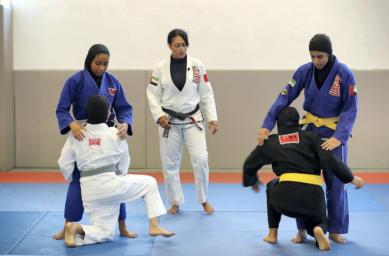 ABU DHABI , UNITED ARAB EMIRATES , AUG 27 – 2017 :-  Rosalind Ferreira , coach ( center ) giving tips during the training of UAE women’s junior national Jiu Jitsu team at the Arena at Zayed Sports City in Abu Dhabi. ( Pawan Singh / The National ) Story by Amith Passela