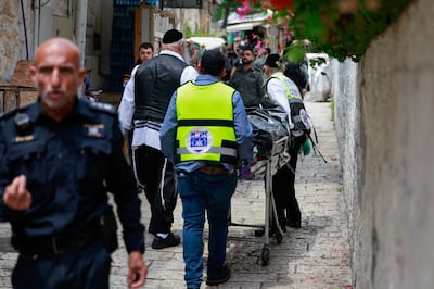 The body of an attacker who, according to the Israeli police was a Turkish citizen, is taken away as Israeli emergency personnel respond to a stabbing attack in Jerusalem. Reuters