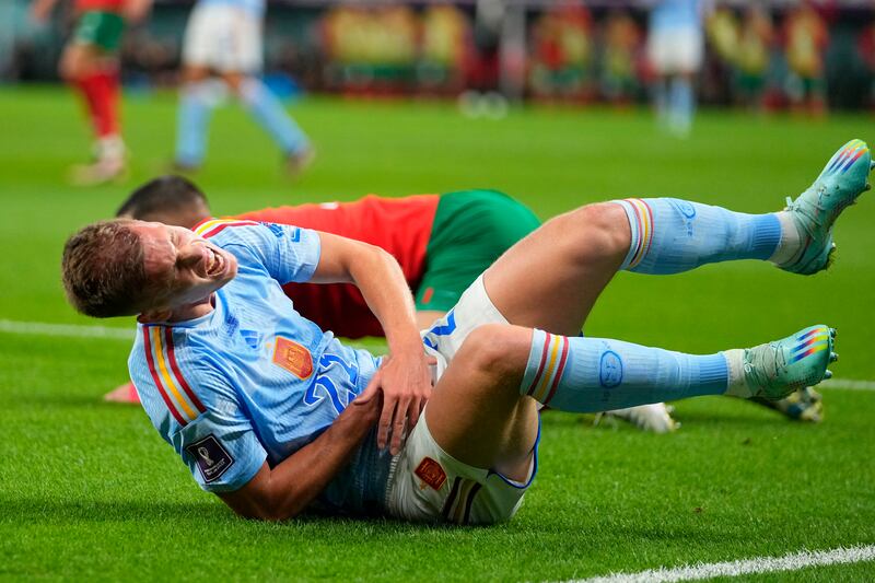 Spain's Dani Olmo grimaces in pain. AP 