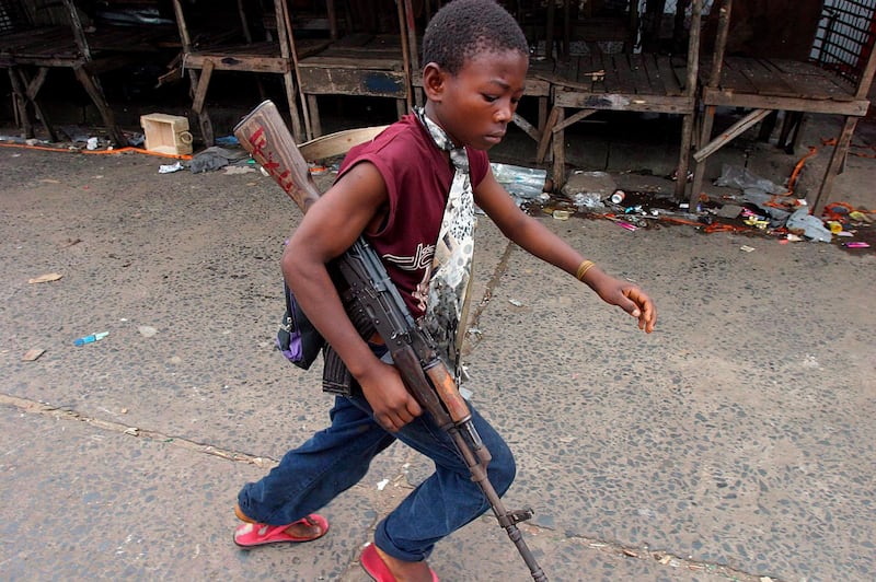 epa03197285 (FILE) A file photograph dated 30 July 2003 showing a Liberian child soldier fighting for Charles Taylor's government forces during the civil war in Monrovia, Liberia. Media reports state that Charles Taylor on 26 April 2012 became the first former African head of state to be convicted by a UN court after he was found guilty in The Hague, Netherlands,  of 11 charges of war crimes and crimes against humanity committed in Sierra Leone, including terror, murder, rape, and conscripting child soldiers. While the court found it could not prove that Taylor did have direct command over rebel operations, presiding judge Richard Lussick said the court had 'found unanimously that Mr Taylor aided and abetted RUF and AFRC rebels in the commission of war crimes and crimes against humanity in Sierra Leone.' The crimes for which he was prosecuted date from November 1996 until the official end of the war, in January 2002.  EPA/NIC BOTHMA *** Local Caption *** 50315640