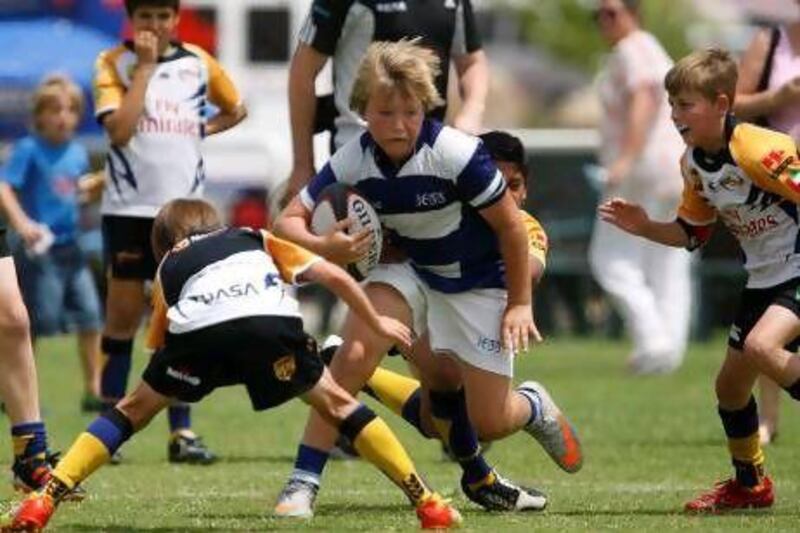 Jess's Findley Ratcliff finds running room during action in the Under 12 category at the Middle East Schools Rugby Union International Festival.