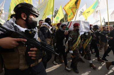 PMF militia members carry the coffin of a militant colleague who died in American air strikes targeting Iran-backed groups in Iraq this month. AFP