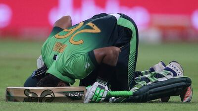 Pakistan's Imam-ul-Haq prays after reaching his century during the third ODI against Sri Lanka in Abu Dhabi. Kamran Jebreili / AP Photo