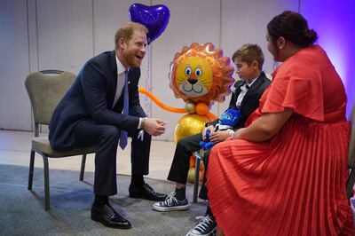 The Duke of Sussex speaks to a family during the annual WellChild Awards at the Hurlingham Club in London. PA