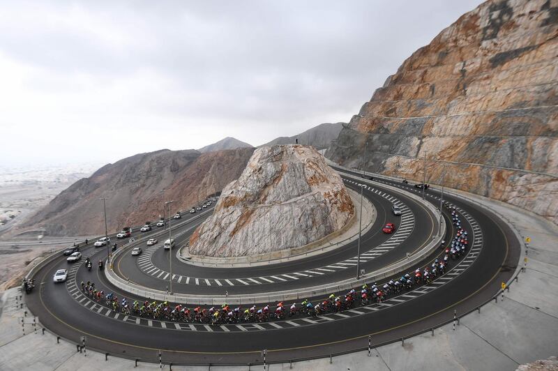 The pack rides the climb of al-Jabal street during the 2019 Tour of Oman bicycle race. AFP