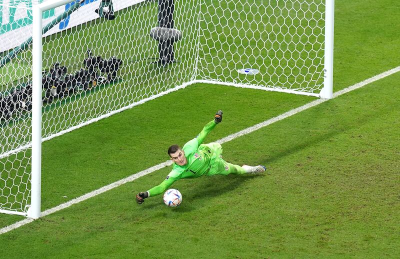 Croatia goalkeeper Dominik Livakovic saves from Japan's Kaoru Mitoma during the penalty shoot-out. PA