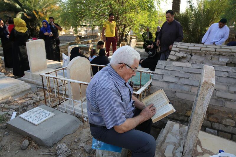 Iraqis gather around the graves of relatives on the first day of the Eid Al Adha holiday in the capital Baghdad.  AFP