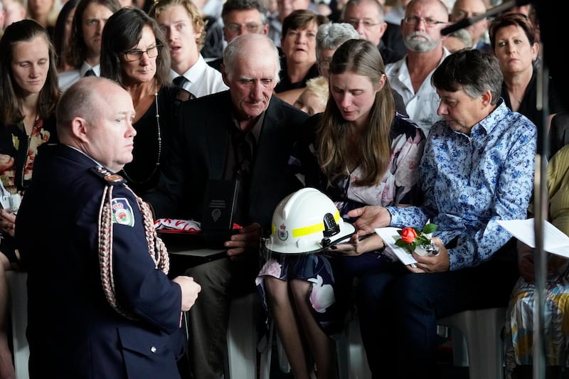 NSW Fire Commissioner Shane Fitzsimmons presenting awards to Sams widow Megan, and mum, Christine during the funeral of NSW RFS volunteer firefighter Samuel McPaul at Holbrook Sports Stadium  in Albury, NSW, Australia. McPaul died  while he was fighting the Green Valley blaze on December 30.  Getty Images