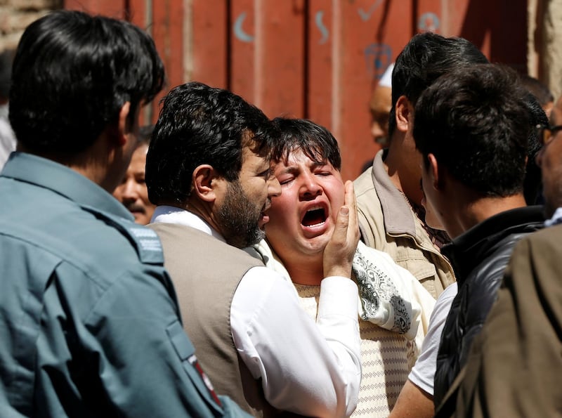 A man reacts as others comfort him at the site of a suicide attack in Kabul, Afghanistan on April 22, 2018. Omar Sobhani / Reuters