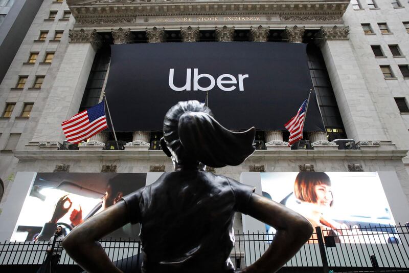 FILE - In this May 10, 2019, file photo the statue of Fearless Girl stands in front of the New York Stock Exchange before Uber, the world's largest ride-hailing service, holds its initial public offering. (AP Photo/Mark Lennihan, File)