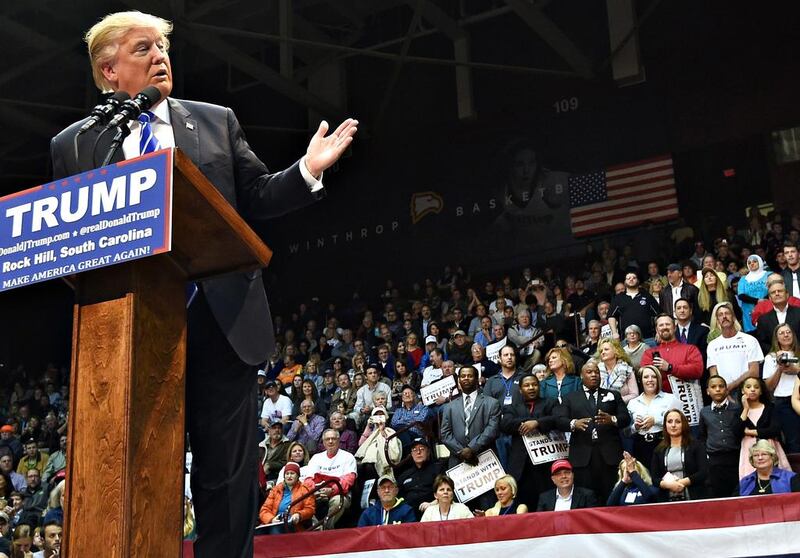 Republican presidential candidate Donald Trump was speaking during a campaign stop at Winthrop University on Friday, January 8, 2016, in Rock Hill, South Carolina when a Muslim woman, wearing a white head scarf and a blue T-shirt emblazoned with the words, “Salam, I come in peace”, stood up in the stands directly behind him in a silent protest, prompting security officers to eject her from the meeting. Rainier Ehrhardt/AP Photo