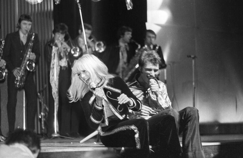 (FILES) A file photograph taken on March 17, 1967 in Paris, shows Sylvie Vartan (L) and Johnny Hallyday singing as they give a concert, the profits of which are to go to cancer research, at the Olympia venue. 
France's best-known rock star Johnny Hallyday has died aged 74 after a battle with lung cancer, his wife Laeticia told AFP on December 6, 2017. / AFP PHOTO / STR
