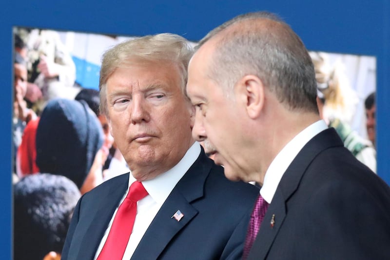 FILE - In this July 11, 2018 file photo, President Donald Trump, left, talks to Turkish President Recep Tayyip Erdogan as they tour the new NATO headquarters in Brussels, Belgium.  Trumpâ€™s decision to withdraw American troops from Syria was made hastily, without consulting his national security team or allies, and over the strong objections of virtually everyone involved in the fight against the Islamic State, according to U.S. officials. Trump stunned his Cabinet, lawmakers and much of the world with the move that triggered Defense Secretary Jim Mattisâ€™ resignation by rejecting the advice of his top aides and agreeing to the pull-out in a phone call with Turkish President Recep Tayyip Erdogan last week, two officials briefed on the matter said. (Tatyana Zenkovich/pool photo via AP)