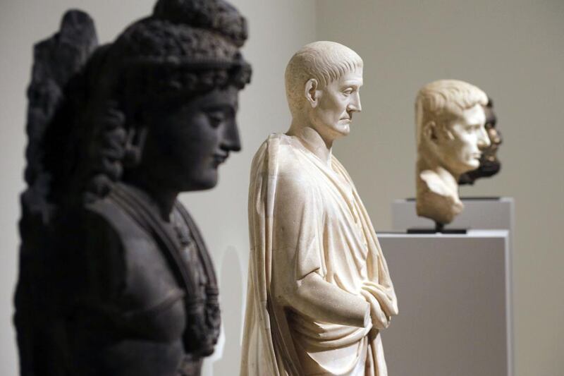 A view of ancient sculptures, one of a Bodhisattva from Pakistan, left, dating back to the 2nd-3rd century and one of a Roman Togatus from the 2nd century. Francois Guillot/AFP