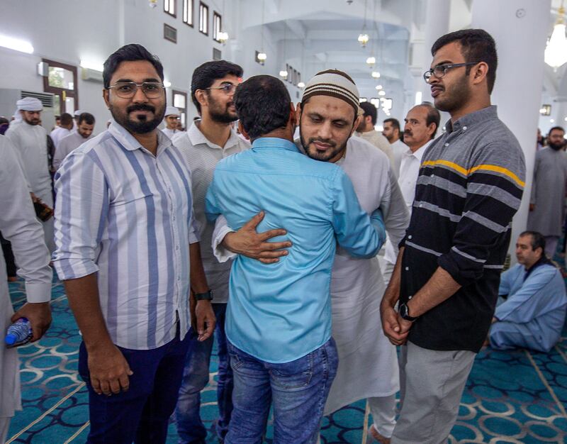 Greeting friends and relatives after morning Eid prayers at Zayed the Second Mosque in Abu Dhabi. Victor Besa / The National