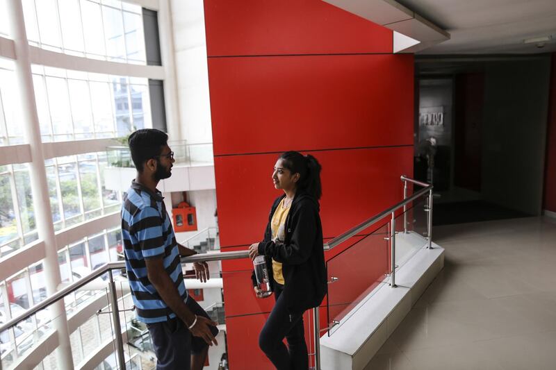 Employees chat in a corridor of Flock's office in Mumbai, India, on Wednesday, June 28, 2017. Flock, a cloud-based team collaboration service that has attracted 25,000 enterprise users and customers, is pitched as a way to share ideas in real time while doing away with communication hierarchies, at a cheaper price than rival services. Photographer: Dhiraj Singh/Bloomberg