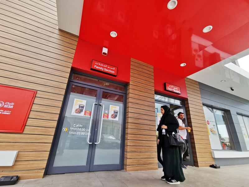 A Saudi woman walks towards the 'family section' while a man comes out of the 'single section' at a McDonald's outlet in Khobar, Saudi Arabia. Reuters