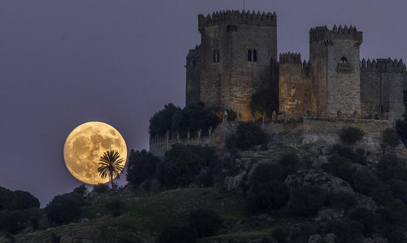 The moon rises behind the castle of Almodovar in Cordoba, southern Spain. Miguel Morenatti / AP Photo