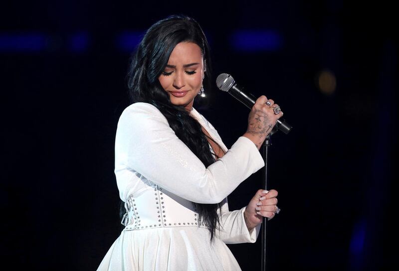 FILE - Demi Lovato performs "Anyone" at the 62nd annual Grammy Awards on Jan. 26, 2020, in Los Angeles. Lovato reveals publicly for the first time details about her near-fatal drug overdose in 2018 in â€œDemi Lovato: Dancing With the Devil,â€ a four-part docuseries debuting March 23, 2021, on YouTube Originals. (Photo by Matt Sayles/Invision/AP, File)