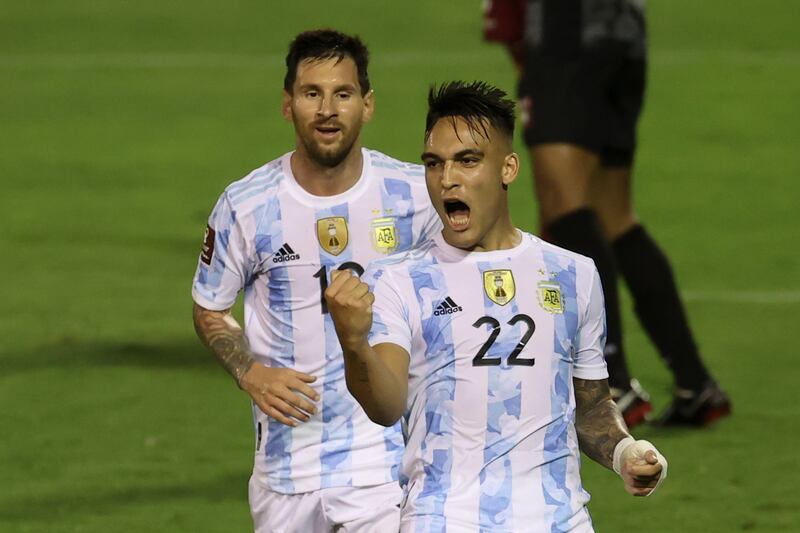 Lautaro Martinez, right, celebrates scoring the opening goal for Argentina against Venezuela beside teammate Lionel Messi. AP