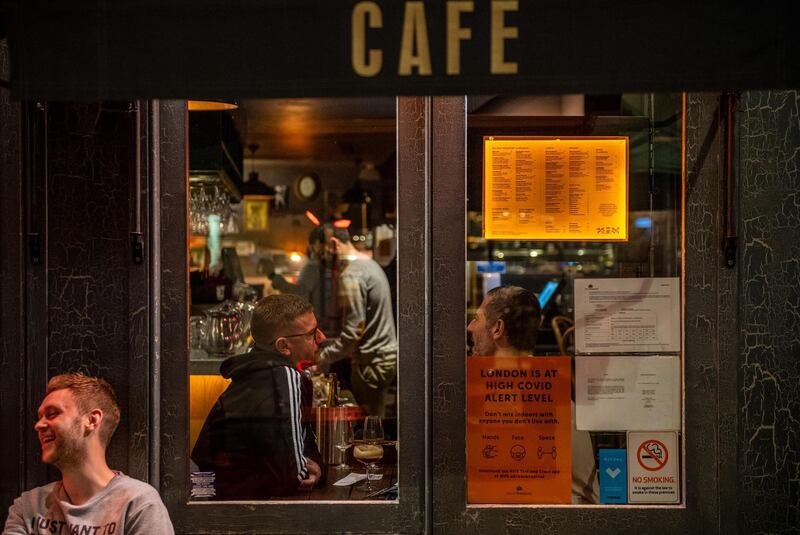 A notice about the High Covid Alert Level in London is seen on a cafe window in the Soho district in London, UK. Bloomberg