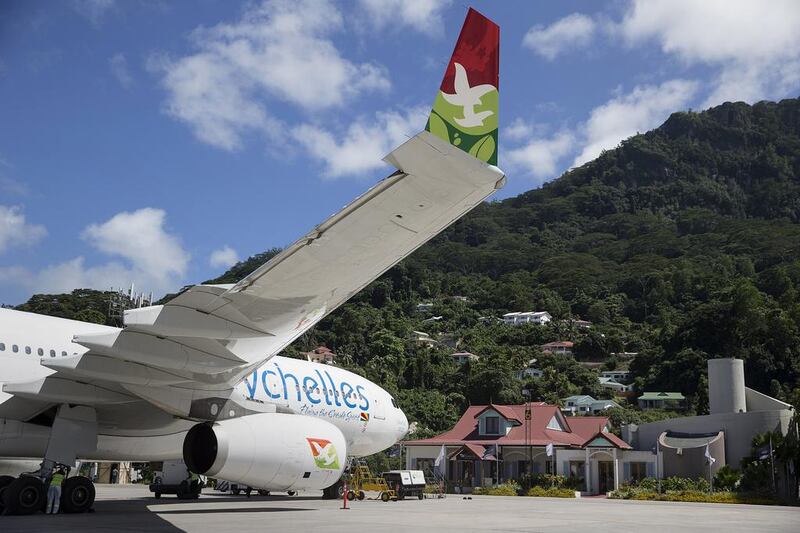 An Air Seychelles plane parked near the Air Seychelles VIP lounge undergoes servicing at Victoria airport. Silvia Razgova / The National