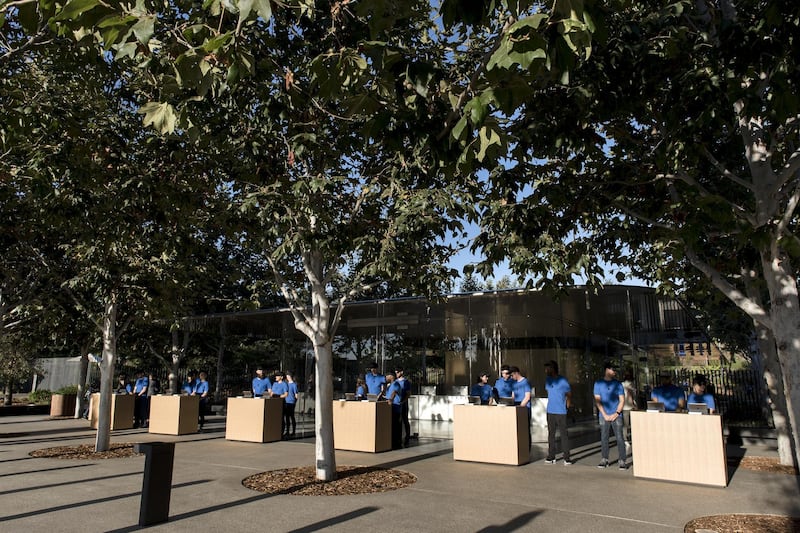 Employees wait for attendees ahead of the  Apple event. Bloomberg