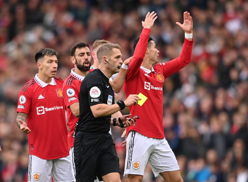 Cristiano Ronaldo is booked by referee Craig Pawson. Getty