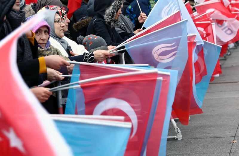 Supporters of Turkish President Recep Tayyip Erdogan hold Turkish flags as they gather at Potsdamer Platz during the Libya summit in Berlin, Germany, January 19, 2020. REUTERS/Christian Mang