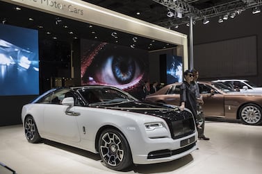 Attendees pose for photographs at the Rolls-Royce Motor Cars Ltd. stand at the Auto Shanghai 2019 show in Shanghai, China, on Thursday, April 18, 2019. China's annual auto show, held in Shanghai this year, opened to the media on April 16 amid the specter of an electric-car bubble and as the world's largest auto market trudges through its first recession in a generation. Photographer: Qilai Shen/Bloomberg