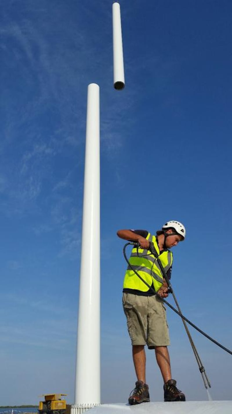 The Trident Support team erect a 120-metre flagpole.