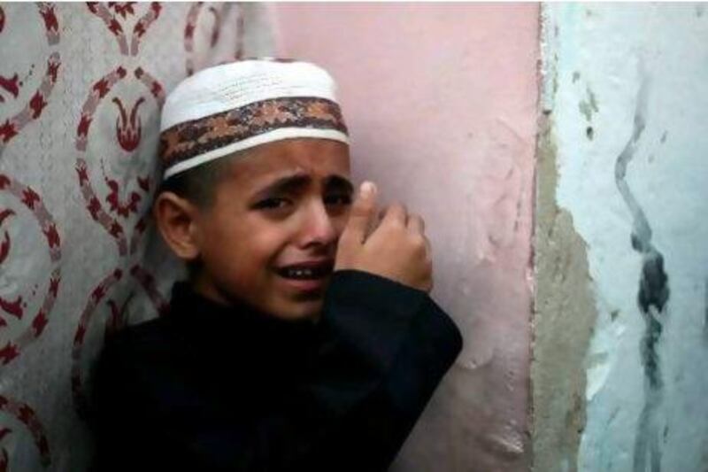 Palestinian Ahmed cries over the death of his father, Salafist leader Hisham Al Saedni, during his funeral at Al Bureij refugee camp in the central Gaza Strip yesterday.