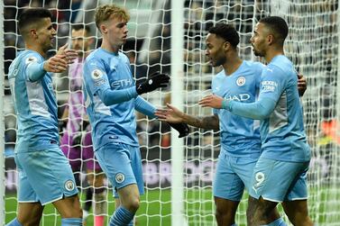 Manchester City's English midfielder Raheem Sterling (2nd R) celebrates with teammates after scoring their fourth goal during the English Premier League football match between Newcastle United and Manchester City at St James' Park in Newcastle-upon-Tyne, north east England on December 19, 2021.  (Photo by Oli SCARFF / AFP) / RESTRICTED TO EDITORIAL USE.  No use with unauthorized audio, video, data, fixture lists, club/league logos or 'live' services.  Online in-match use limited to 120 images.  An additional 40 images may be used in extra time.  No video emulation.  Social media in-match use limited to 120 images.  An additional 40 images may be used in extra time.  No use in betting publications, games or single club/league/player publications.   /  