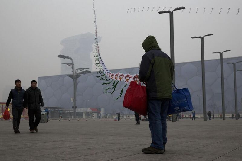 In this picture taken February 23, 2014, a street vendor flies kites printed with the Beijing Olympic games mascot image near the Water Cube aquatic center in Beijing, China. The Water Cube, where U.S. swimmer Michael Phelps made history by winning eight gold medals, has been transformed into a water park popular among local families. Its operators even peddle purified glacier water under the Water Cube brand for additional income. Beijing, which spent more than $2 billion to build 31 venues for the 2008 Summer Games, is reaping some income and tourism benefits from two flagship venues, though many sites need government subsidies to meet hefty operation and maintenance costs. Ng Han Guan / AP Photo